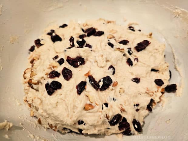 The cranberries and pecans are stirred into the dough.