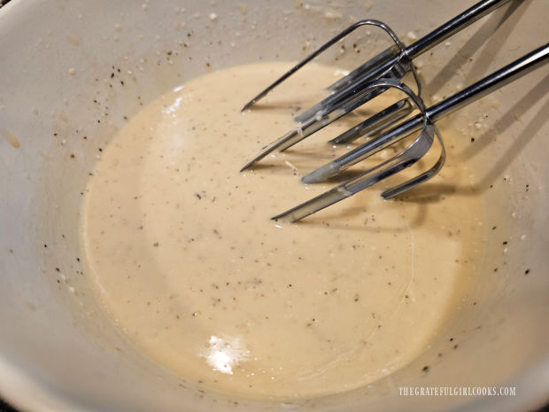 Electric mixer is used to blend ingredients for creamy Italian salad dressing.