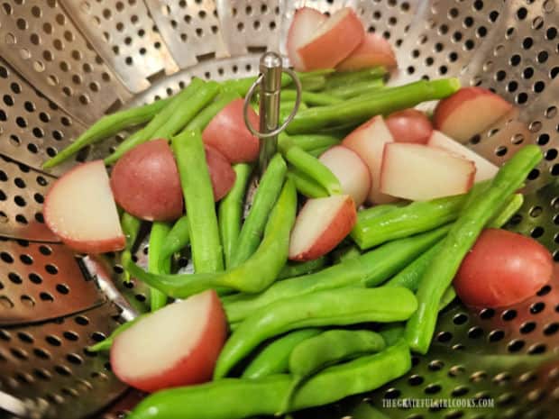 Cut green beans and red potatoes cook until tender in a steamer basket.