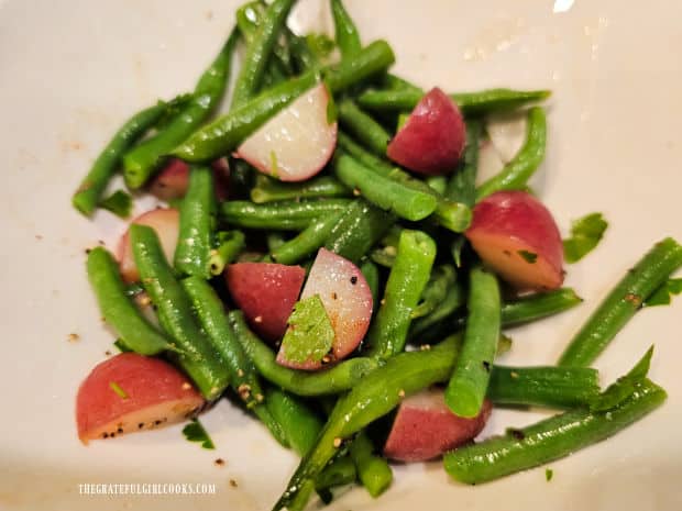 The hot veggies are stirred until butter melts and spices are incorporated.