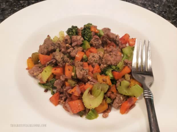 Ground Beef Veggie Skillet is done cooking and is served hot, in a white bowl.