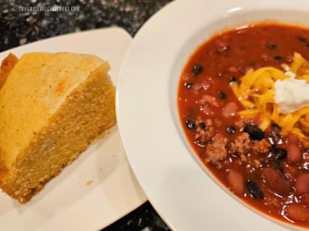 A bowl of chili, with a slice of Instant Pot Cornbread on the side.