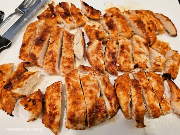 Air fryer chicken breast strips are cut into thin slices and served.