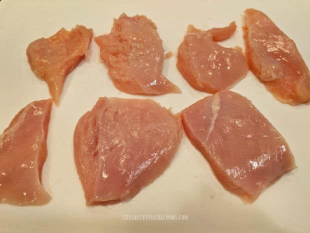 Chicken breast pieces are dried with paper towel, then pounded with a mallet.