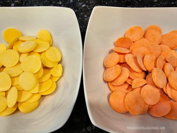 Two white bowls with yellow and orange melting candy wafers in them.