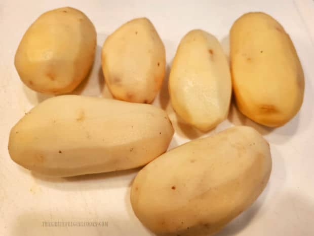 Six medium russet potatoes are peeled, then rinsed.