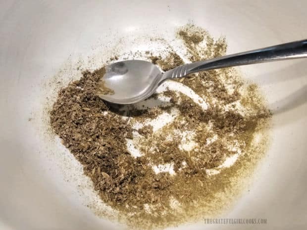 Spices for the sausage patties are combined in a bowl.