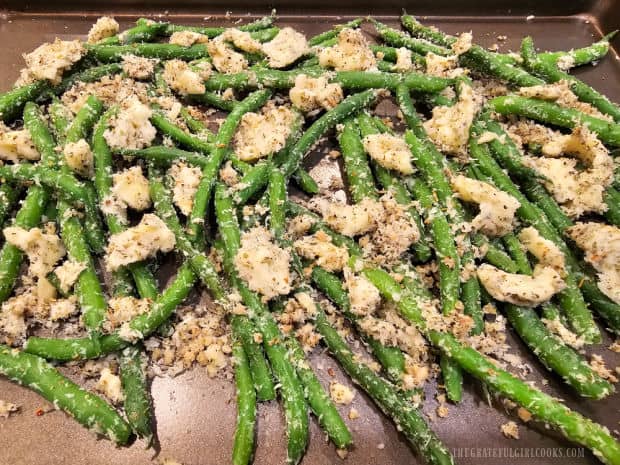 Combined beans, butter and spices are laid on baking sheet for cooking.