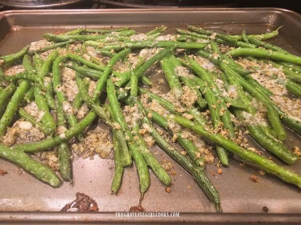 Halfway through baking, cheese has melted, and beans are turned over.