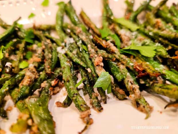 The Parmesan Garlic Green Beans are served, garnished with parsley.