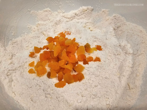 Finely chopped dried apricots are tossed well in the flour mixture.