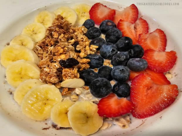 The overnight oats are topped with a variety of fresh sliced fruit and granola.