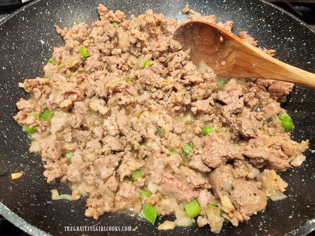 After being cooked, grease is removed (and discarded) and the meat mixture is seasoned.