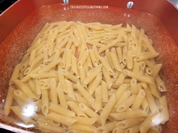 Penne pasta is cooked in boiling water until al dente.