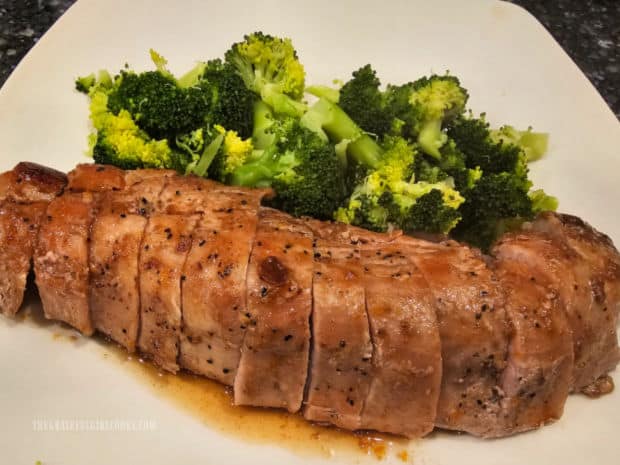 After being sliced the maple orange pork tenderloin is served with broccoli on the side.