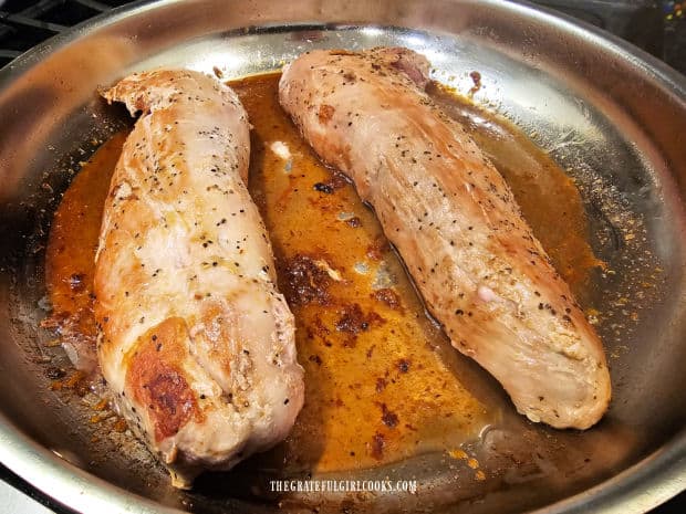 Pork tenderloins are placed in glaze in skillet and turned until fully coated.