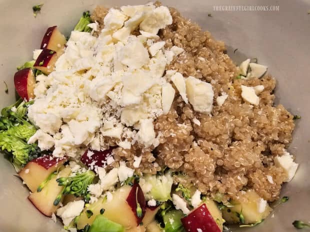 Crumbled feta cheese and cooked quinoa are added to the apples and broccoli.