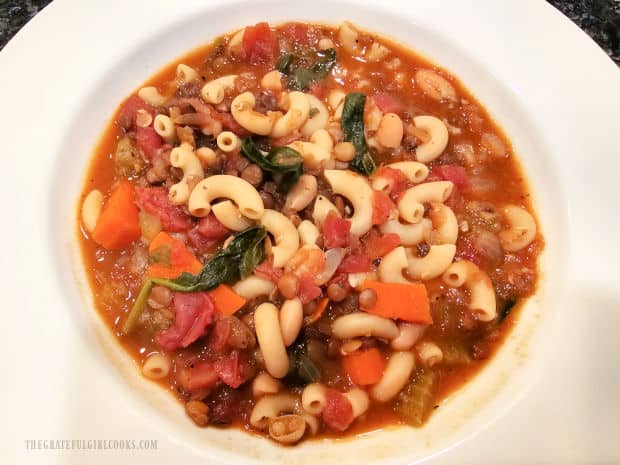 Easy lentil minestrone soup served in a large white bowl.