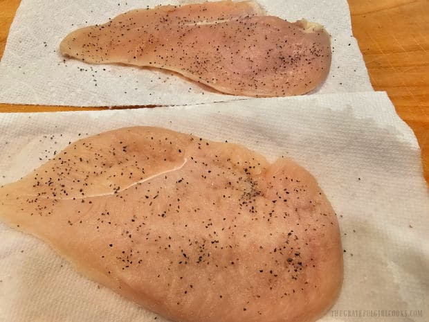 Lightly seasoned chicken breasts patted dry on paper towels.